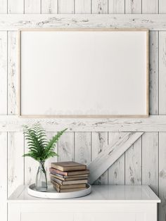 there is a white shelf with books and a plant on it in front of the frame