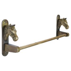 two horse head hooks are attached to the wall