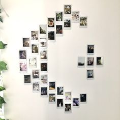 a white wall with many pictures arranged in the shape of a heart