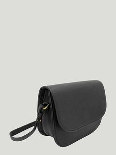 a black leather purse on a gray background