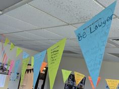 several pennants hanging from the ceiling in an office