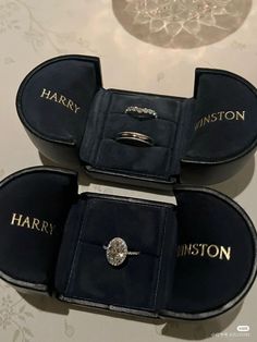 three harry potter rings in their cases on a table