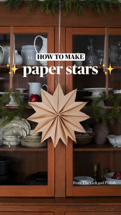 a paper star hanging from the side of a wooden hutch