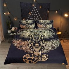 a bed with an elephant on it and some string lights in the room behind it