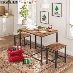 a table and two stools in a room with christmas decorations on the wall behind them