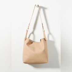 With A Unique, Double-Loop Handle Design, This Bucket Bag Puts A Modern Twist On A Beloved Silhouette. Count On It To Carry All Of Your Daily Essentials With Stylish Ease. * Polyurethane; Polyester Microsuede Lining * One Inner Zip Pocket * Magnetic Snap Closure * Imported Dimensions * 13"H, 16"W, 5.5"D * 10" Handle Drop Anthropologie Bags, Handle Design, Taupe Color, Daily Essentials, Snap Closure, Bucket Bag, Zip Pockets, Anthropologie, Bag Lady