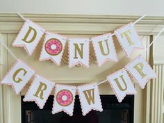 donut grow up banner hanging from fireplace mantel