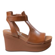 Give your mojo a boost in these 3” camel brown platform wedges. The upfront design and significant lift lengthen your silhouette, and they offer just the right amount of coverage to wear spring through fall. If you love OTBT’s Jaunt, Mojo is the upgrade you’ve been waiting for. In camel brown, this style pairs well with vintage wide-leg denim and bohemian favorites.Features:- Women's platform wedge sandals- Upfront design with cut-outs- Round peep toeMaterials: - Handcrafted with genuine leather Event Shoes, Silver Platforms, Athleisure Shoes, Sorority Rush Dresses, Bachelorette Dress, Casual Bodysuit, Travel Brand, Jumpsuit Shorts Rompers, Platform Wedge Sandals