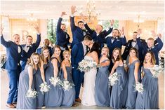 a group of people that are standing in front of each other with their arms in the air