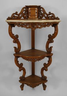 an ornate wooden shelf with marble top in the shape of a clock on it's side