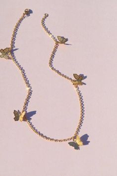 a necklace with butterflies attached to it