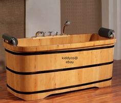 a wooden bath tub sitting on top of a hard wood floor