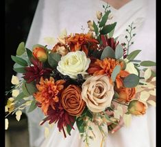 a bridal bouquet with orange and white flowers