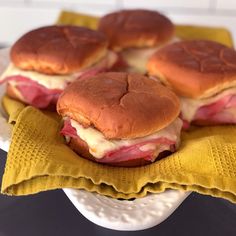 ham and cheese sliders on a yellow napkin