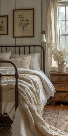 a bedroom with a bed, dresser and two pictures on the wall above it's headboard