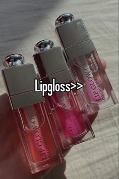 three bottles of lip glosses sitting on top of each other