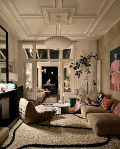 a living room filled with lots of furniture and decor