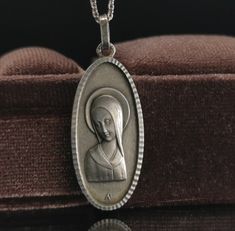 A beautiful genuine 1950s vintage solid silver Virgin Mary pendant in Art Deco style, floats from a 17-inch long 925 silver necklace. In good condition, would make a nice gift for someone special! Material: silver, hallmarked Pendant measures: 15 x 33 mm total weight (with chain): 6.5g Box on photos is NOT included! A stunning religious jewelry shop well worth a visit ... https://www.etsy.com/shop/SacredMagic Art Deco Sterling Silver Engraved Necklace, Vintage Polished Pendant Necklace, Vintage Pendant Necklace With Polished Finish, Silver Art Deco Medallion Necklace, Vintage Necklace With Polished Finish For Gift, Vintage White Gold Sterling Silver Necklace, Engraved Sterling Silver Art Deco Necklace, Vintage Medallion Necklace With Polished Finish, Antique Silver Necklace With Polished Finish