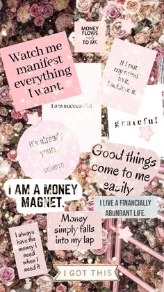 some pink and white stickers on a wall with words that say, i am a money magnet