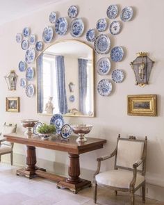 a dining room with blue and white plates on the wall