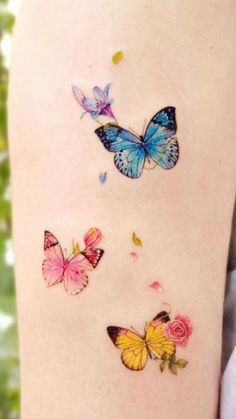 three butterflies on the back of a woman's thigh