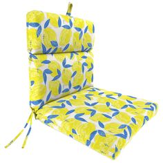 a yellow chair cushion with blue and white flowers on it, tied to the back