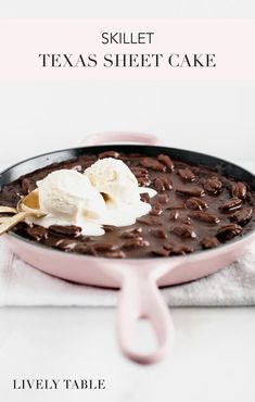 a skillet with chocolate pudding and ice cream on top, ready to be eaten