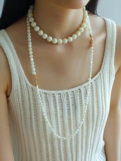 This elegant necklace showcases simplicity at its finest, featuring smooth white shell beads delicately strung together. The minimalist design exudes a timeless charm, perfect for both casual and formal occasions. With its versatile style, this necklace effortlessly complements any outfit, adding a touch of sophistication to your look. Metal: 18K Recycled Gold Plated On Brass Gemstone: Mother of Pearls(6.5mm/8mm/12mm) 6.5mm/8mm Bead Chain Length: 400mm 12mm Bead Chain Length: 390mm Weight: 26.5/ Elegant Pearl Chain Beaded Necklaces, Elegant Pearl White Mother Of Pearl Beaded Necklaces, Elegant Cream Necklace With Pearl Charm, Elegant Cream Necklaces With Pearl Charm, Delicate White Mother Of Pearl Necklace, White Pearl Long Necklace With Clavicle Chain, Minimalist White Pearl Beaded Necklaces, White Minimalist Necklace For Layering, Minimalist White Necklace For Layering