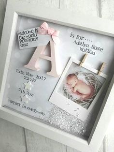 a baby's birth announcement in a box with clothes pins and a name tag