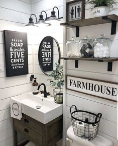 the bathroom is decorated in white and black with farmhouse decor on the wall above the sink