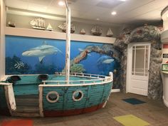 an aquarium with dolphins and other marine creatures in it's display case at the children's museum