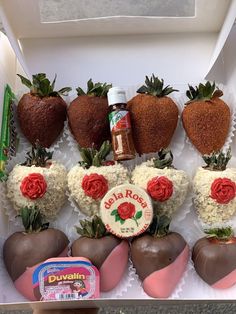 chocolate covered strawberries in a box with strawberry toppings on the top and flowers around them