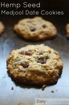 some cookies are sitting on a cookie sheet and the words hemp seed medjo date cookies