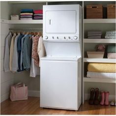 a white washer and dryer sitting next to each other in front of a closet