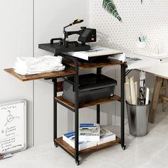 a desk with a sewing machine on it in a room that has white walls and flooring