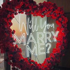 a heart shaped wreath with the words will you marry me?