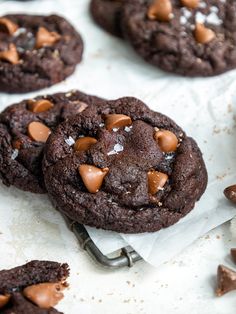 chocolate cookies with sea salt and chopped almonds on white parchment paper, ready to be eaten