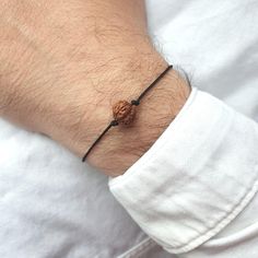 🧡 This minimalist handmade rudraksha bracelet features a single sacred rudraksha seed carefully strung on a black cord. Revered for its spiritual significance, the rudraksha seed is believed to possess powerful healing properties and is regarded as a symbol of divine protection and connection to the divine realms. Wearing this bracelet may enhance one's sense of inner peace, harmony, and mindfulness, while also promoting clarity of thought and heightened spiritual awareness. With its profound s Rudraksha Breslet For Men, Rudraksha Bracelet Men, Rudraksh Breslet For Man, Rudraksh Pendant For Men, 5 Mukhi Rudraksha, Rudraksha Bracelet, Bracelets Men, Divine Protection, Rudraksha Beads