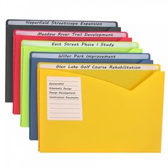 several folders with labels on them are lined up