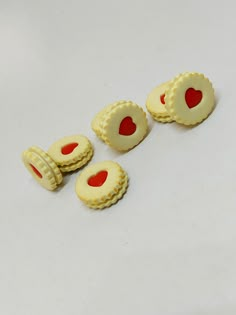 three cookies with hearts cut out of them sitting on a white surface next to each other