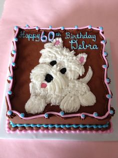 a birthday cake with a white dog on it