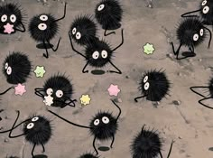 a group of black and white furry animals with stars on their backs, standing in front of each other