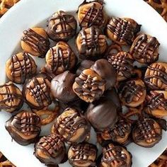 a white plate topped with chocolate covered donuts