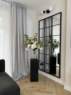 a living room filled with furniture and a large mirror