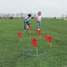 two children playing with red and blue golf tees