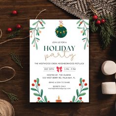 a holiday party card with holly wreaths and bells on it, next to marshmallows