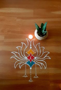 a potted plant sitting on top of a wooden floor next to a rang art design