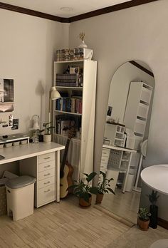 a room with a desk, bookshelf and mirror