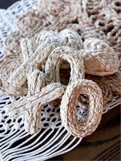 several pieces of rope are on a doily that is laying on top of each other