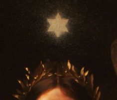 a woman with a crown on her head looking up at the stars above her head